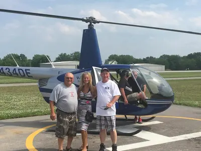 a group of people standing in front of a helicopter at Put-in-Bay Island Club #71 in Put-in-Bay