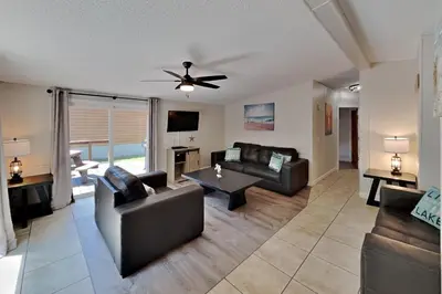 a living room with two couches and a table at Put-in-Bay Island Club #101 in Put-in-Bay