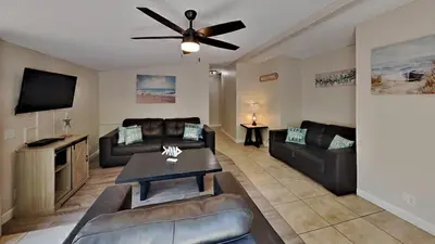 a living room with leather furniture and a ceiling fan at Put-in-Bay Island Club #101 in Put-in-Bay