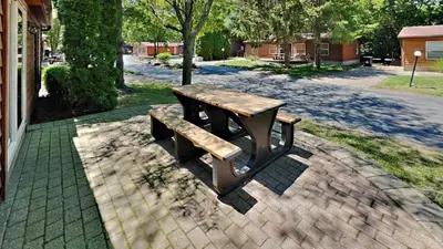a picnic table and a bench on a brick sidewalk at Put-in-Bay Island Club #104 in Put-in-Bay