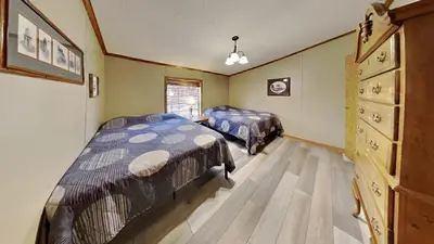 a bedroom with two beds and a dresser at Put-in-Bay Island Club #74 in Put-in-Bay