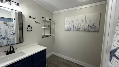 a bathroom with a sink and two pictures on the wall at Put-in-Bay Island Club #97 in Put-in-Bay