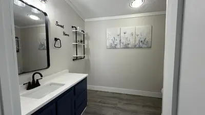 a bathroom with a sink and a mirror at Put-in-Bay Island Club #97 in Put-in-Bay