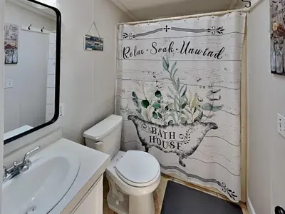 a bathroom with a toilet and a sink and a shower curtain at Put-in-Bay Island Club #97 in Put-in-Bay