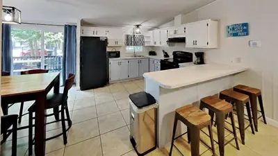 a kitchen with a counter and a table and chairs at Put-in-Bay Island Club #97 in Put-in-Bay