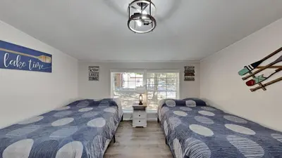 a bedroom with two beds and a window at Put-in-Bay Island Club #113 in Put-in-Bay
