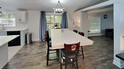 a kitchen and living room with a table and chairs at Put-in-Bay Island Club #113 in Put-in-Bay