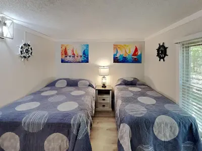 a bedroom with two beds and a window at Put-in-Bay Island Club #66 in Put-in-Bay