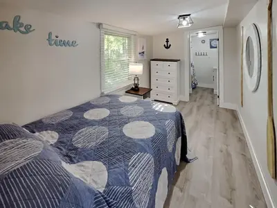 a bedroom with a bed and a dresser in it at Put-in-Bay Island Club #66 in Put-in-Bay
