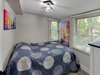 a bedroom with a bed in a room with windows at Put-in-Bay Island Club #66 in Put-in-Bay