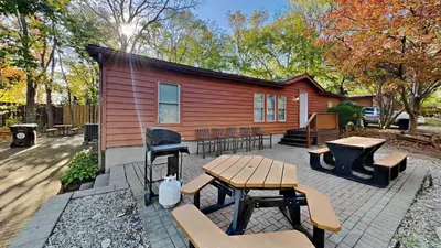 a house with a picnic table and chairs in front of it at Put-in-Bay Island Club #66 in Put-in-Bay
