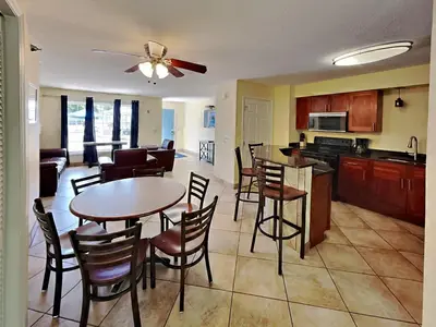 a kitchen and living room with a table and chairs at Put-in-Bay Poolview Condo #3 in Put-in-Bay