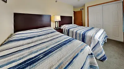 two beds in a hotel room next to each other at Put-in-Bay Poolview Condo #4 in Put-in-Bay