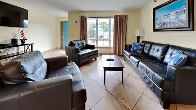 a living room with leather couches and a table at Put-in-Bay Poolview Condo #4 in Put-in-Bay