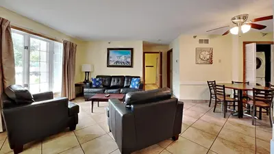 a living room with couches and a dining room at Put-in-Bay Poolview Condo #4 in Put-in-Bay