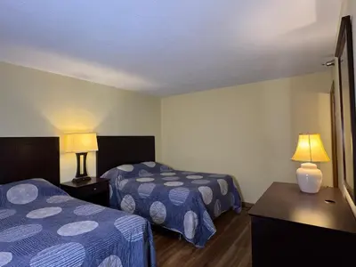 a hotel room with two beds and two lamps at Put-in-Bay Poolview Condo #5 in Put-in-Bay
