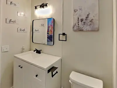 a bathroom with a white toilet and a mirror at Put-in-Bay Island Club #4 in Put-in-Bay