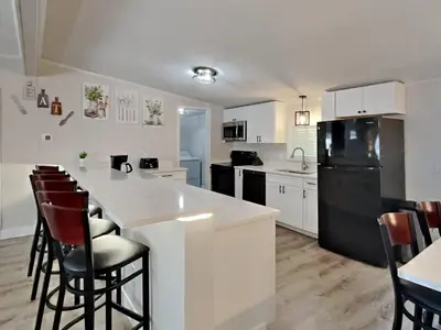 a kitchen with white cabinets and a black refrigerator at Put-in-Bay Island Club #4 in Put-in-Bay