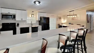 a kitchen with a bar with chairs and a counter top at Put-in-Bay Island Club #4 in Put-in-Bay