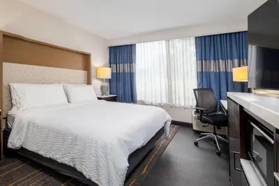 a hotel room with a bed and a desk at Holiday Inn Weirton-Steubenville Area in Weirton