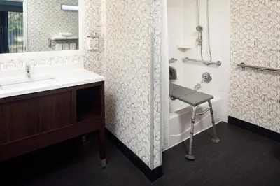 a bathroom with a sink and a shower at Holiday Inn Weirton-Steubenville Area in Weirton