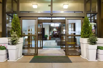 an office lobby with doors and potted plants at Holiday Inn Weirton-Steubenville Area in Weirton