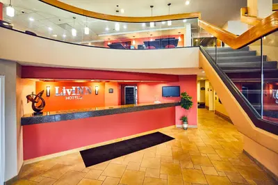 a lobby of a law firm with stairs and a staircase at LivINN Hotel Cincinnati North/ Sharonville in Sharonville