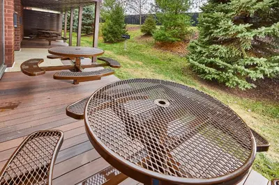 a picnic table and chairs on a wooden deck at LivINN Hotel Cincinnati North/ Sharonville in Sharonville