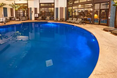 a large blue swimming pool in a building at LivINN Hotel Cincinnati North/ Sharonville in Sharonville