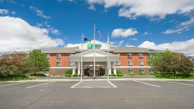 a building with a parking lot in front of it at Holiday Inn Express Hotel & Suites Portland by IHG in Portland
