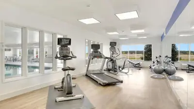 a gym with treadmills and ellipticals in a room at Holiday Inn Express Hotel & Suites Portland by IHG in Portland