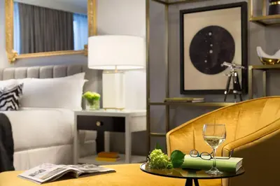 a hotel room with a table with a glass of wine at Hotel LeVeque, Autograph Collection in Columbus