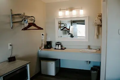 a bathroom with a sink and a mirror at Berlin Village Inn in Berlin