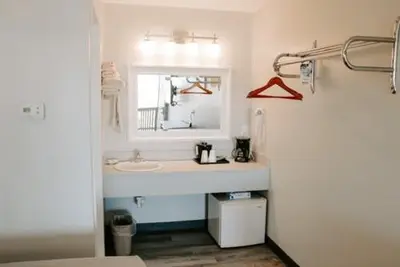 a bathroom with a sink and a mirror at Berlin Village Inn in Berlin