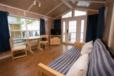 a bedroom with a bed and a table and a desk at Cedar Point's Lighthouse Point in Sandusky
