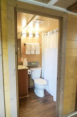 a small bathroom with a toilet and a sink at Cedar Point's Lighthouse Point in Sandusky