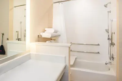 a white bathroom with a tub and a shower at Fairfield Inn & Suites by Marriott Akron Stow in Stow