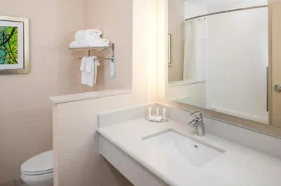a bathroom with a sink and a toilet and a mirror at Fairfield Inn & Suites by Marriott Akron Stow in Stow
