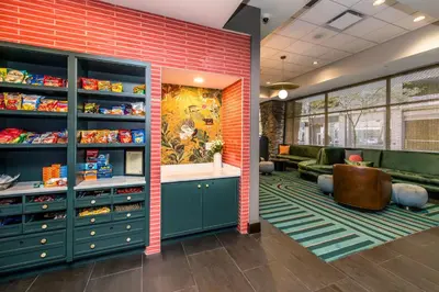 a store with green cabinets and a brick wall at Voco The Clair Cincinnati Downtown by IHG in Cincinnati