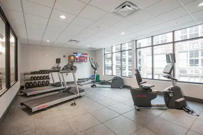 a gym with treadmills and exercise equipment in a building at Voco The Clair Cincinnati Downtown by IHG in Cincinnati