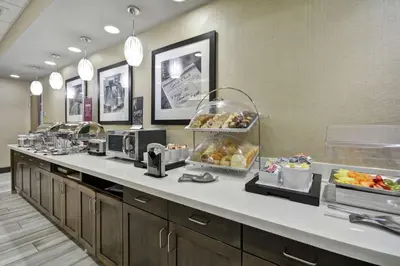 a buffet line in a hotel room with food at Hampton Inn Blue Ash/Cincinnati, OH in Blue Ash