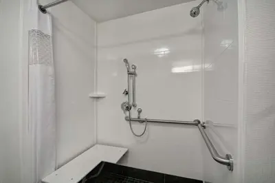 a white bathroom with a shower and a sink at Hampton Inn Blue Ash/Cincinnati, OH in Blue Ash