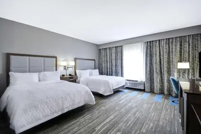 a hotel room with two beds and a window at Hampton Inn Blue Ash/Cincinnati, OH in Blue Ash