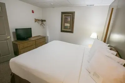 a hotel room with a bed and a television at Lodging on the Square in Berlin