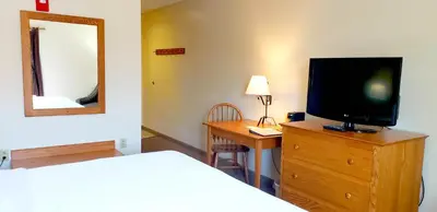 a bedroom with a bed and a television on a dresser at Lodging on the Square in Berlin