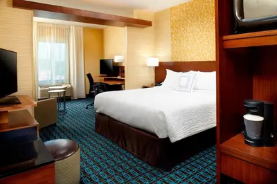 a hotel room with a bed and a television at Fairfield by Marriott Inn & Suites Wheeling at The Highlands in Triadelphia