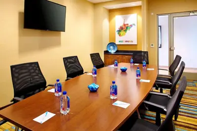 a conference room with a large wooden table and chairs at Fairfield by Marriott Inn & Suites Wheeling at The Highlands in Triadelphia