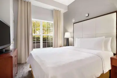 a bedroom with a large white bed and a window at Homewood Suites by Hilton Columbus-Dublin in Dublin