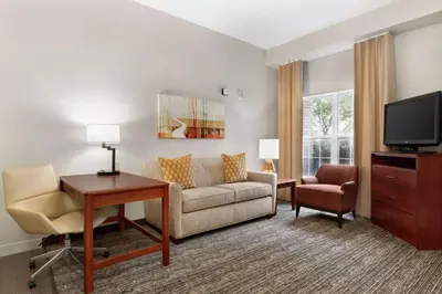 a living room with a couch and a tv at Homewood Suites by Hilton Columbus-Dublin in Dublin