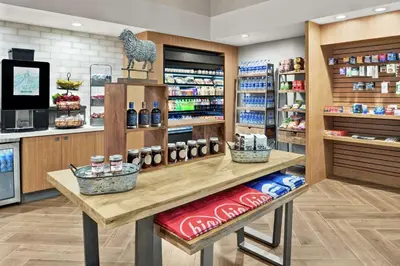 a grocery store aisle with a counter with food at Embassy Suites by Hilton Columbus Dublin in Dublin